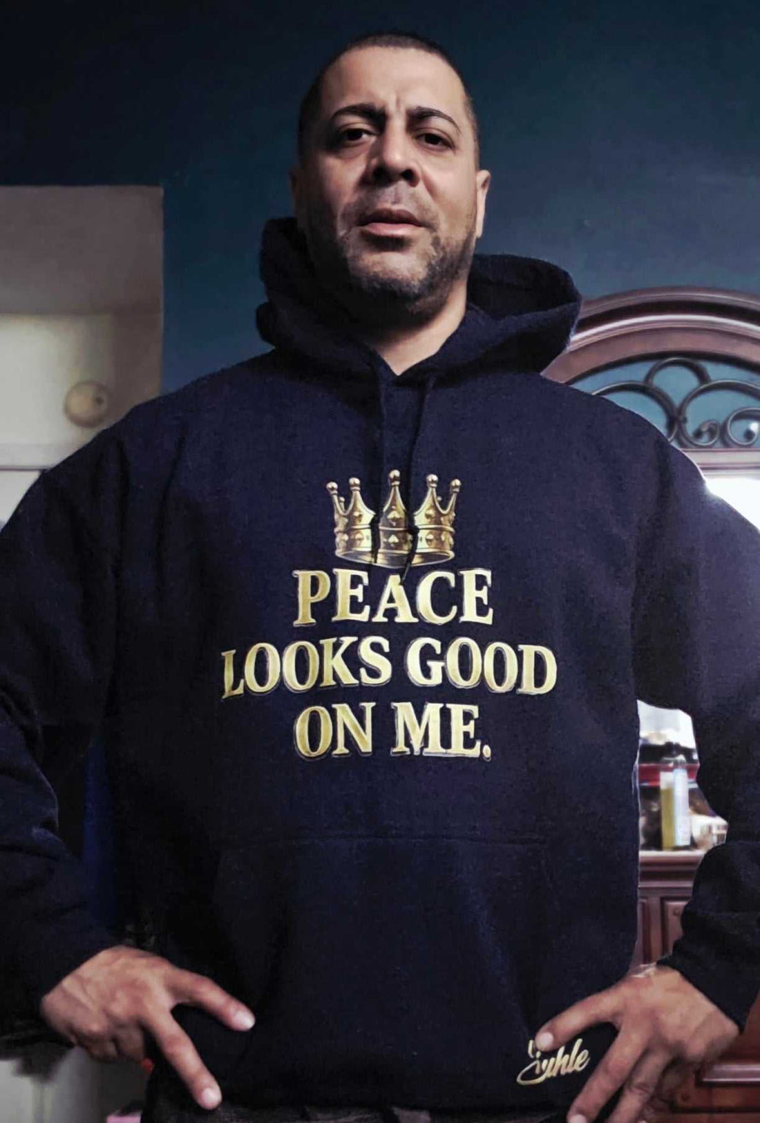 Forest green Peace Looks Good On Me Hoodie with cream typography and gold crown logo